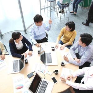 Employees in a meeting drinking coffee